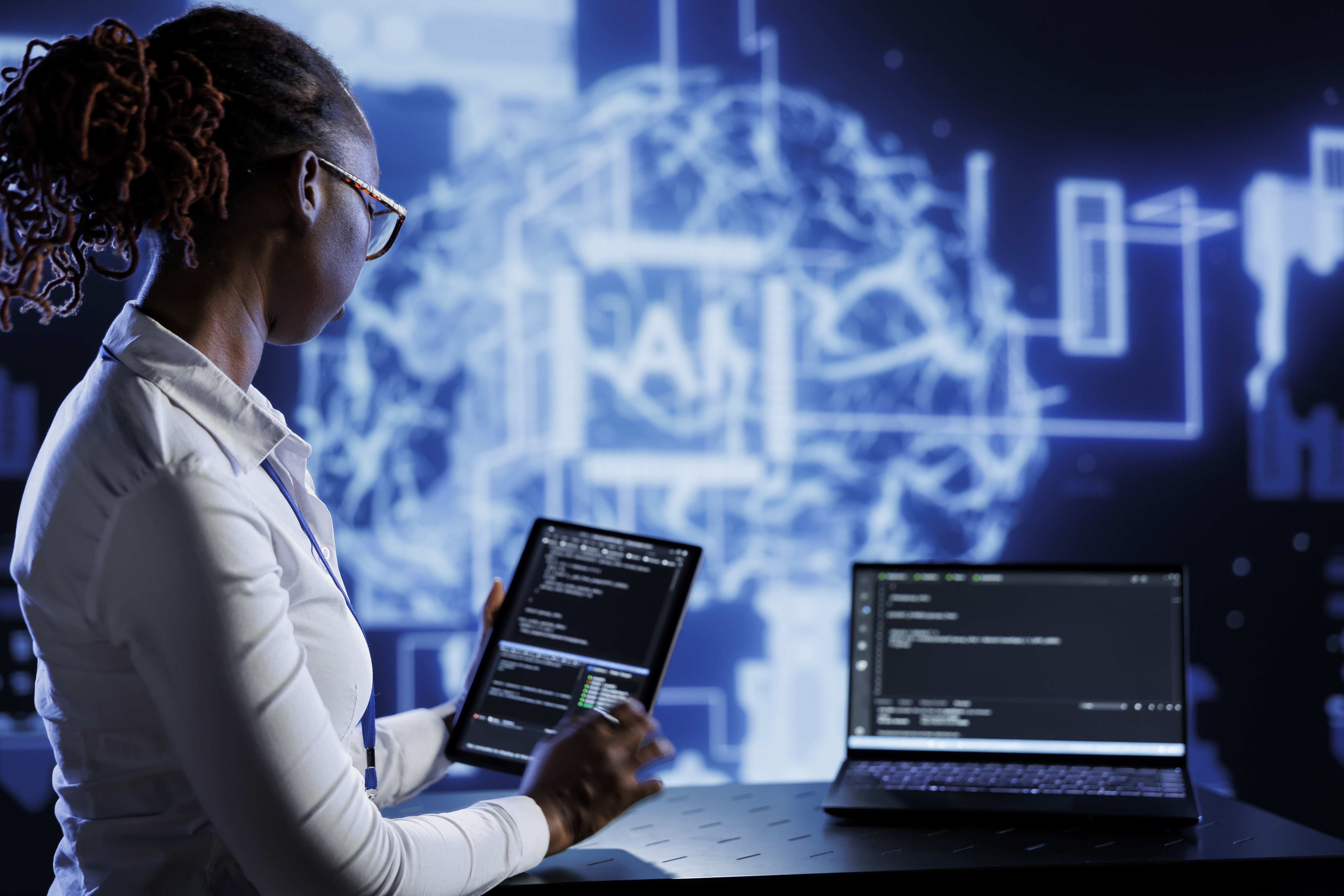 An IT professional updating AI systems that support human work.
